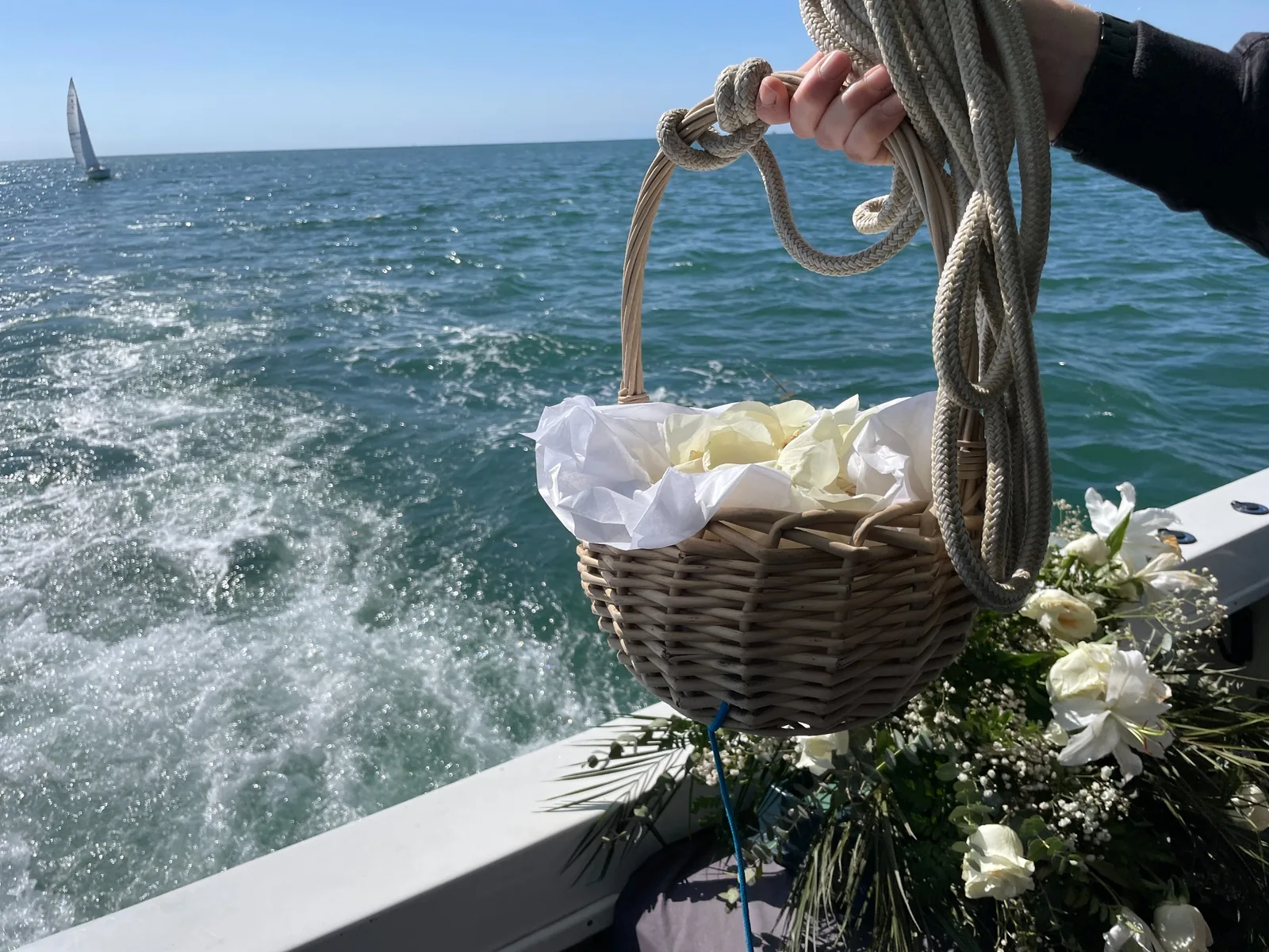 burial-at-sea-flower-petals-memorial-los-angeles-optimized Basket of white flower petals and memorial flowers aboard a yacht during a burial at sea off the Los Angeles coast.